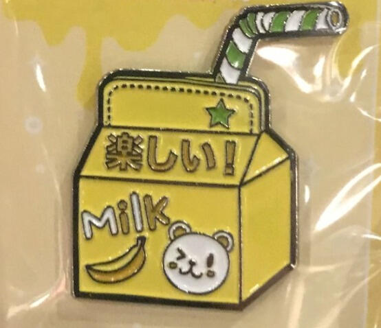 Besidesthepoint A pin of a yellow milk carton that says "milk" and has an illustration of a banana and a white bear.
