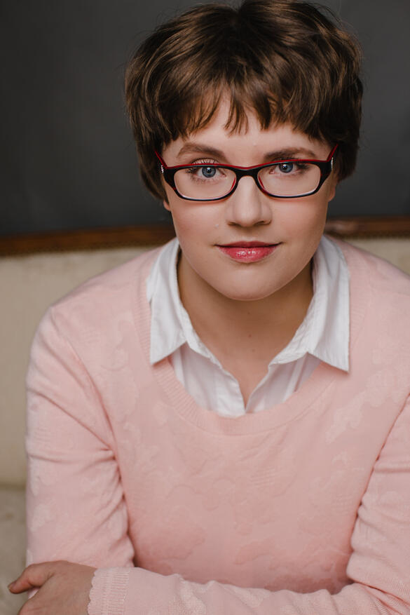 Melissa J. Lackie A photo of a person with light skin and short brown hair. She is wearing glasses and a light pink shirt. She is smiling.